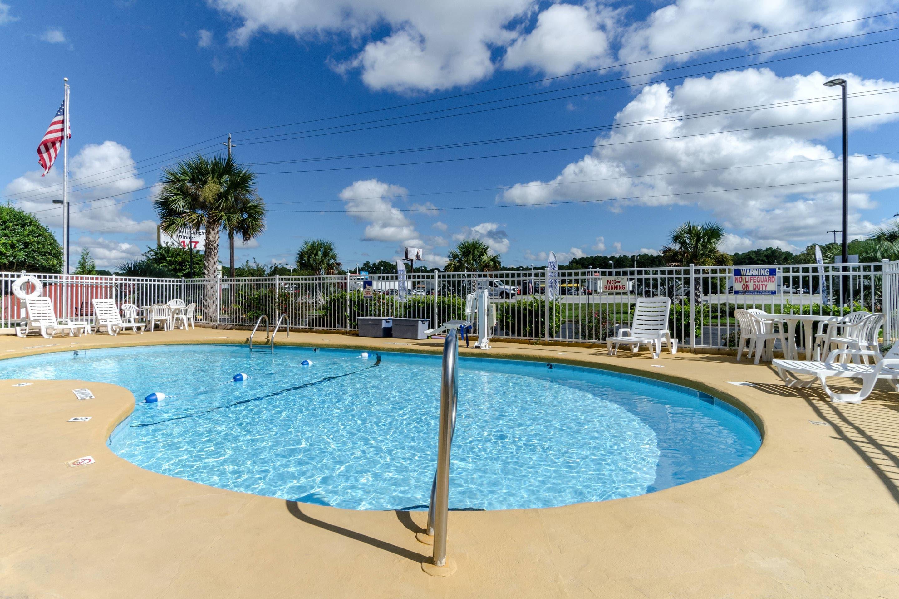 Outdoor pool | Rodeway Inn & Suites Jacksonville near Camp Lejeune
