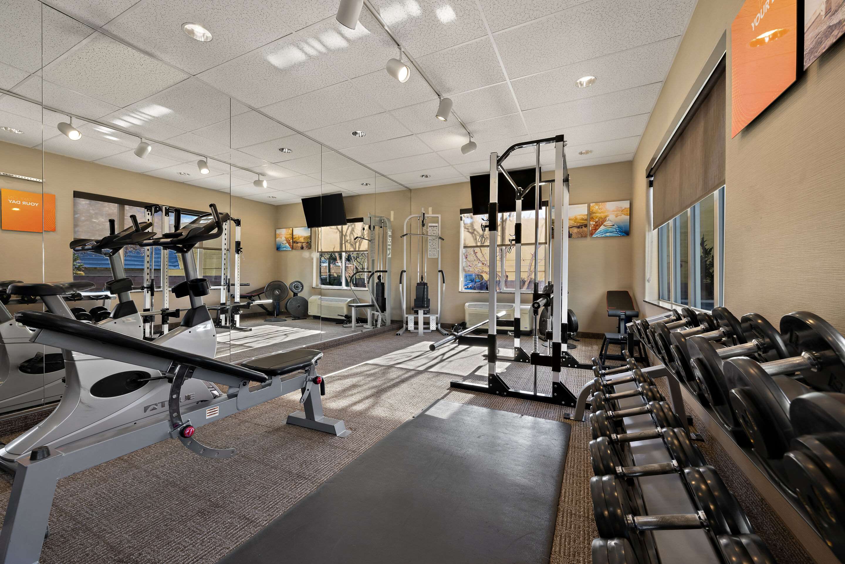 Exercise room with cardio equipment and weights