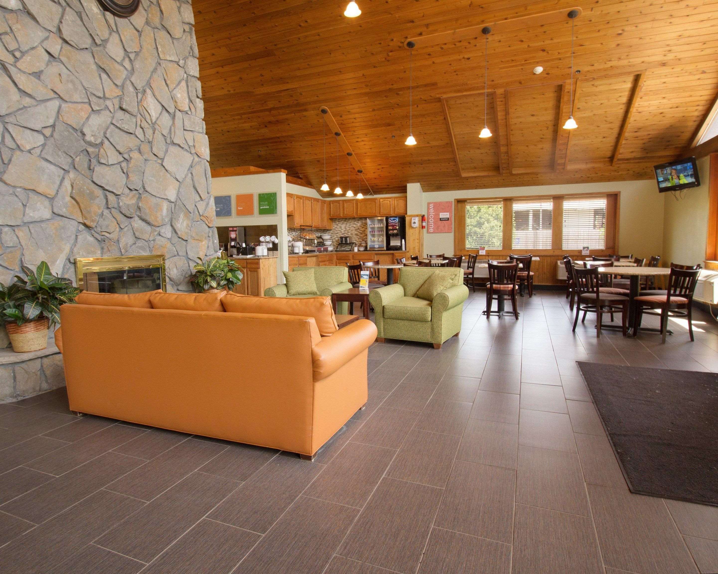 Relax by the fireplace in the lobby | Comfort Inn & Suites Syracuse-Carrier Circle