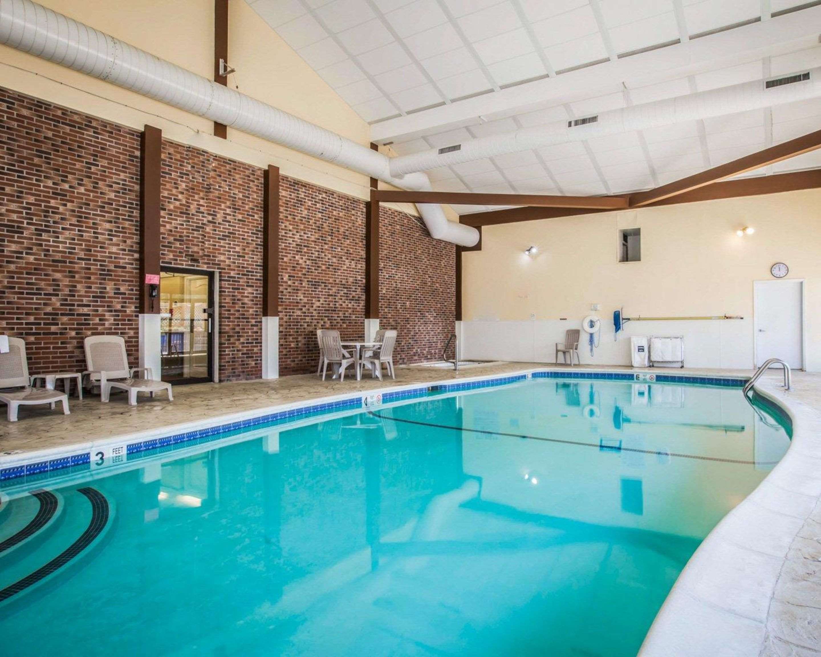 Indoor pool with sitting area | Clarion Inn & Suites at the Outlets of Lake George