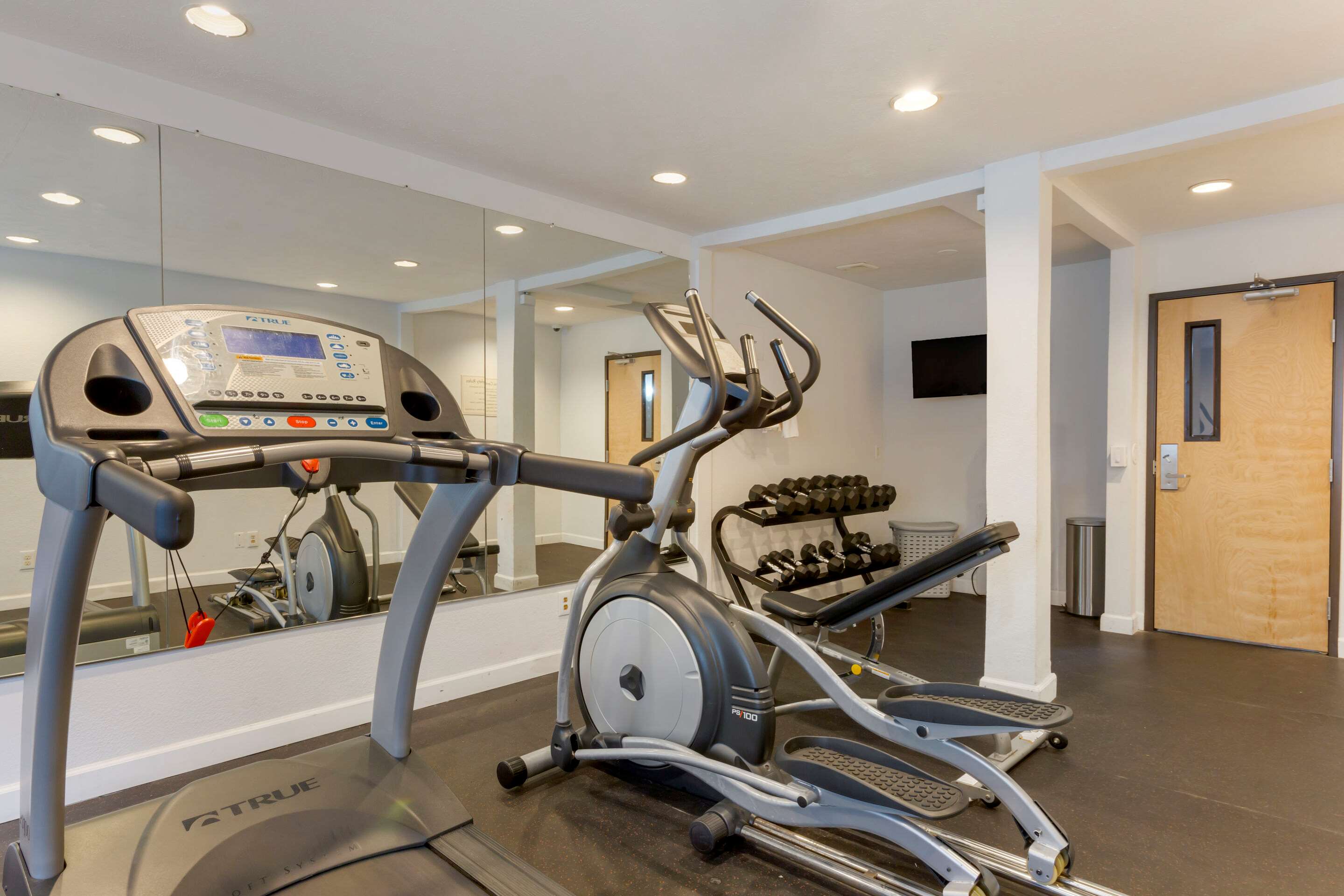 Exercise room with cardio equipment and weights