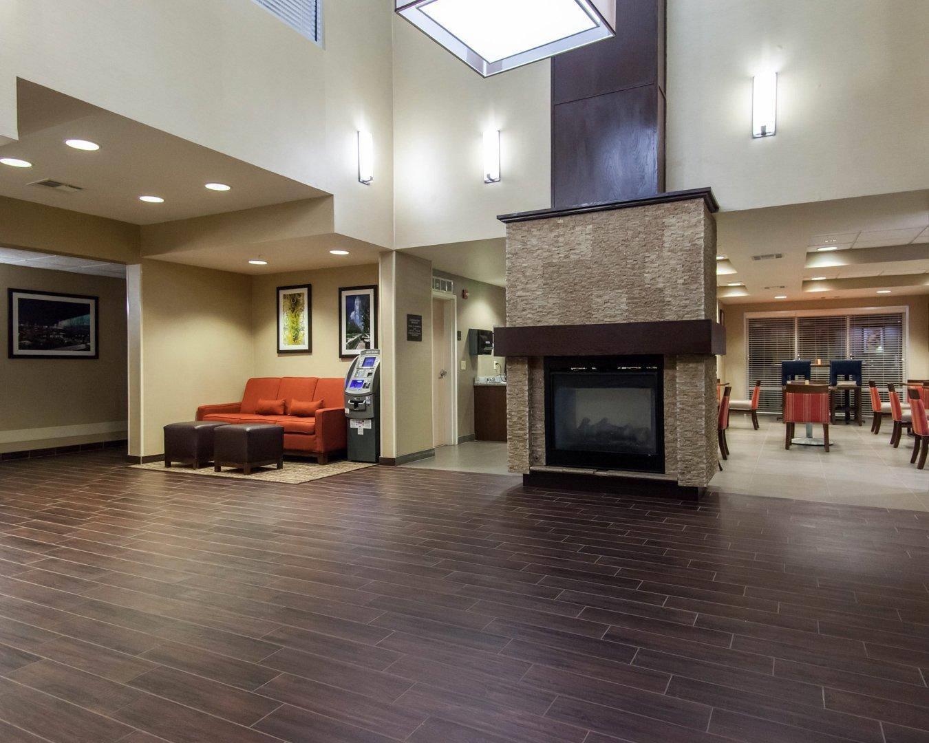Relax by the fireplace in the lobby | Comfort Suites Central/I-44